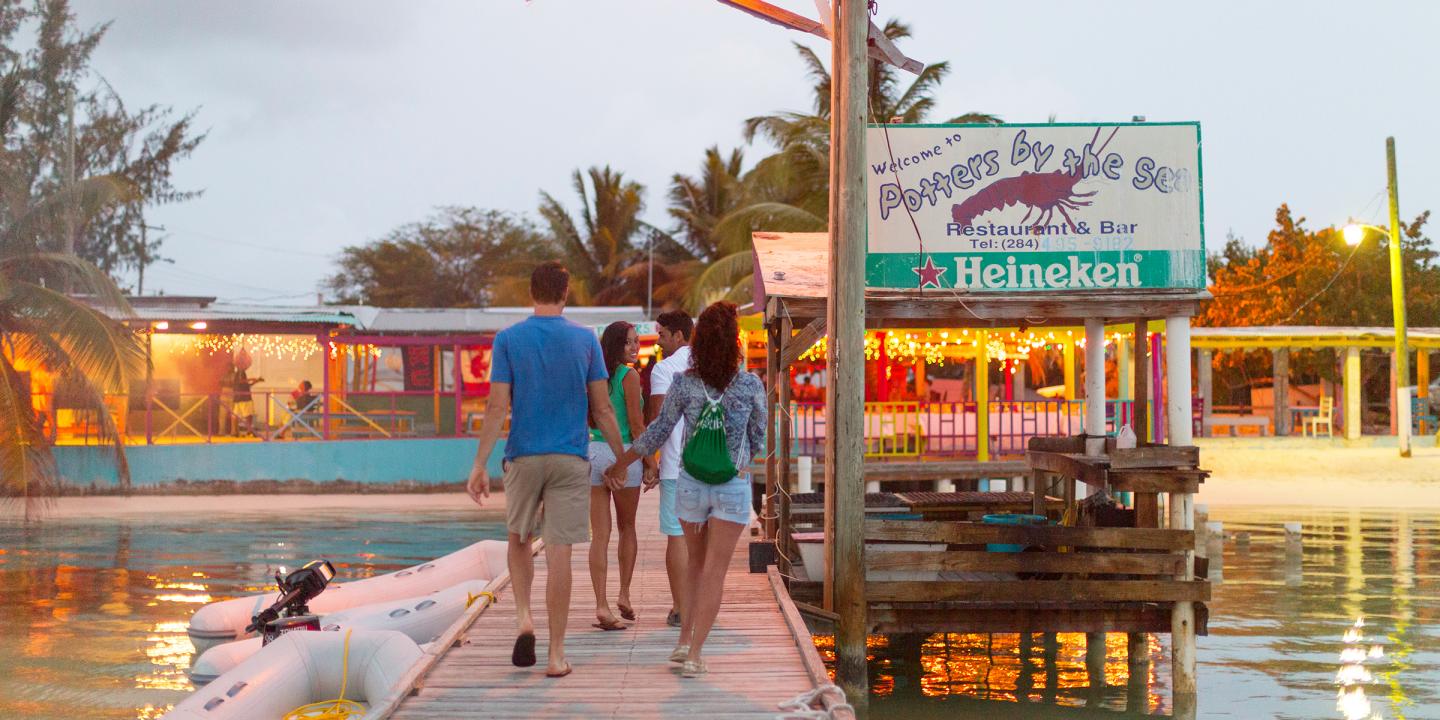 Island cove with anchored sailboats and turquoise water